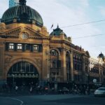 brown building with cars passing infront