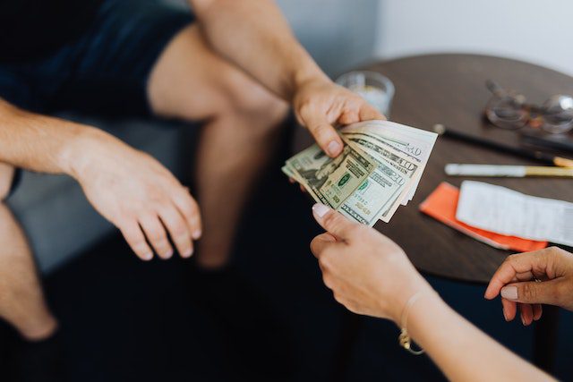 Pexels - Person Giving Money to Another Person