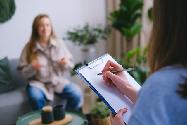 psychologist taking notes during appointment