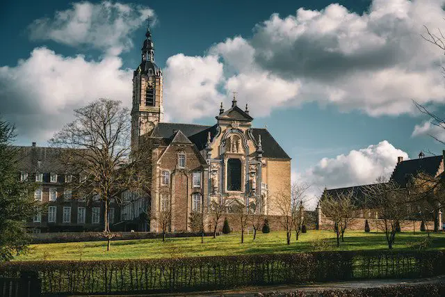 A Monastery Near the Green Grass Field Under the Cloudy Sky