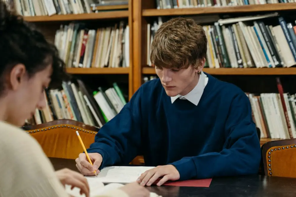 Pexels - a man and woman studying in the library