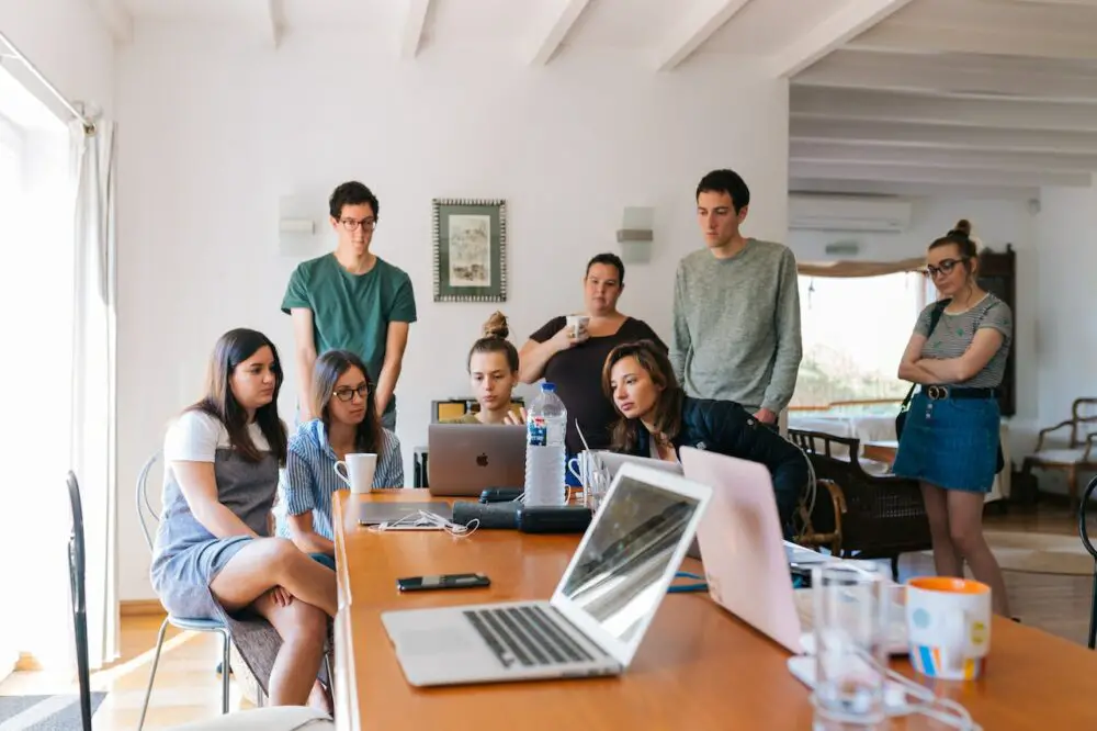 group of people watching a laptop