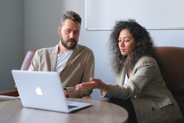 Focused man working with female colleague in office