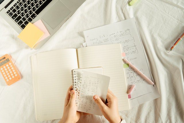 Person Tearing A Page From A Notebook