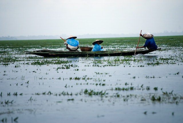 Men riding boat on body of water