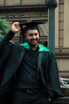 a newly college graduate man smiling