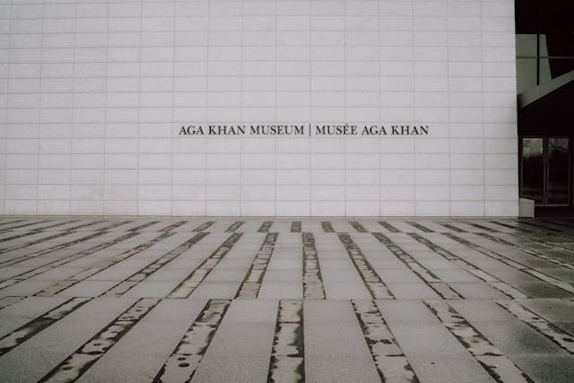 name of aga khan museum on white wall