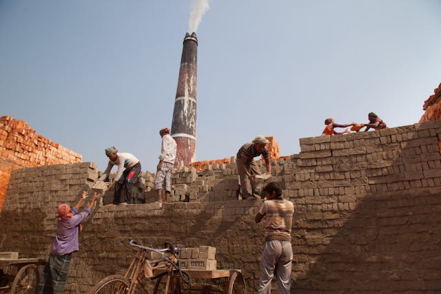 people building a brick wall