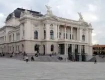 people walking beside white concrete structure