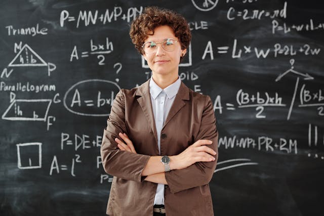 photo of woman standing in front of blackboard