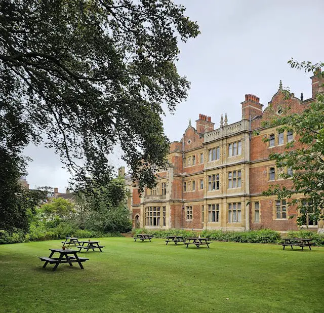 tables and benches on lawn of sidney sussex college in cambridge