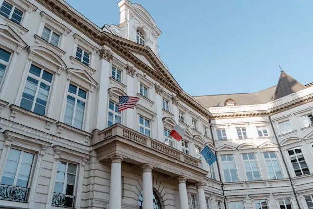 three flags on a balcony of building