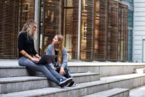 two women having conversation on stairs