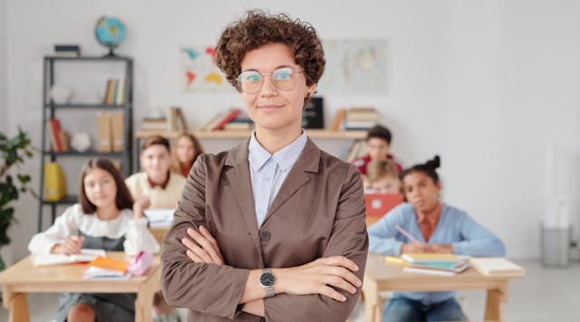 woman in brown blazer wearing eyeglasses