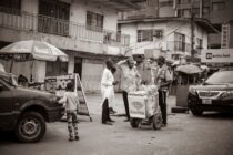 a group of people stand outside a shop