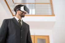 a man in a suit wearing vr goggles