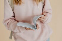 close up shot of a person holding a notebook