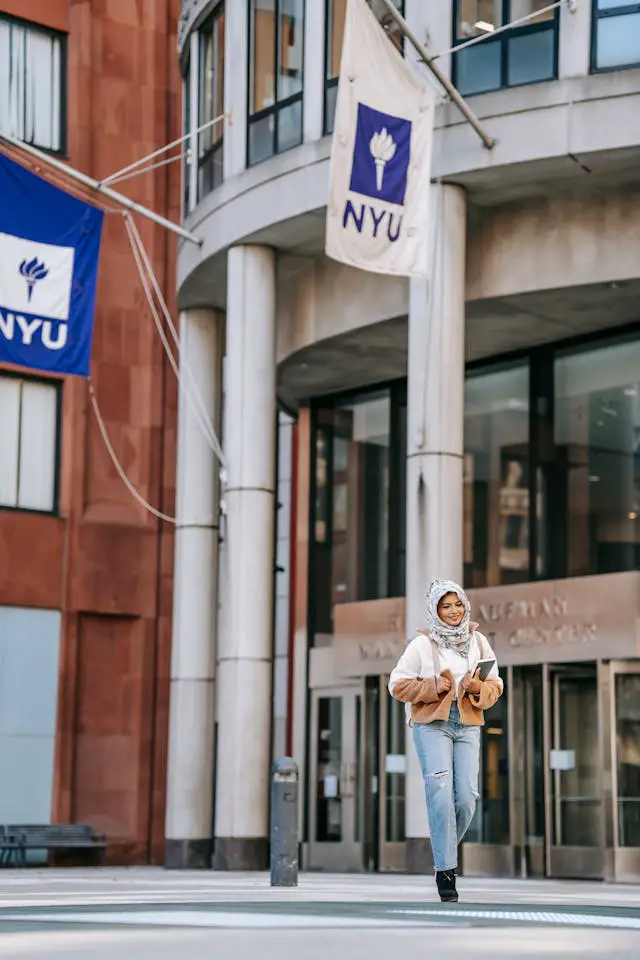 content young muslim woman crossing street after studies