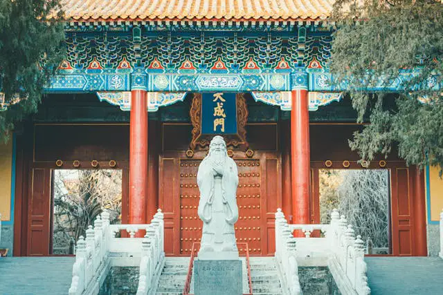 gray concrete statue near the wooden door