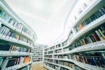 low angle photo of white bookshelves with assorted book lot inside room