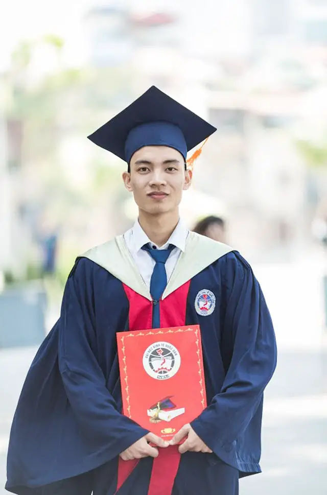 man in toga holding diploma