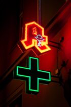 neon pharmacy signs in berlin at night