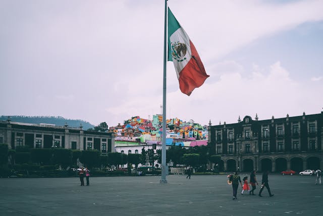 people near mexican flag