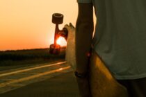 person holding longboard