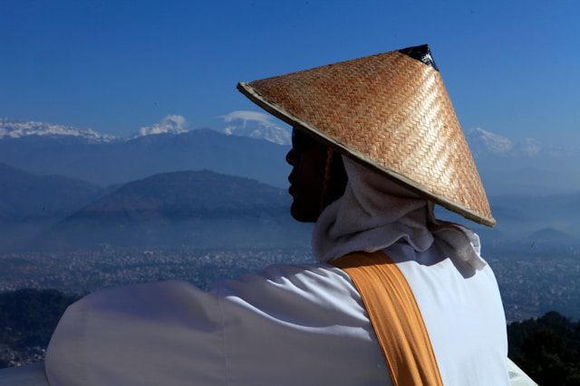 person wearing brown hat looking through during daytime