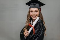 photo of happy woman holding diploma