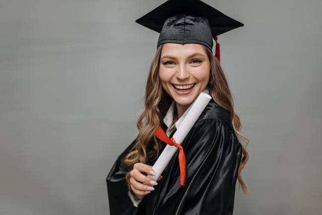 photo of happy woman holding diploma