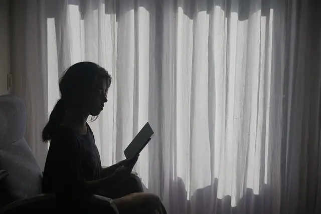 reading woman book women window