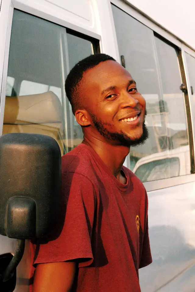 smiling man in red t shirt