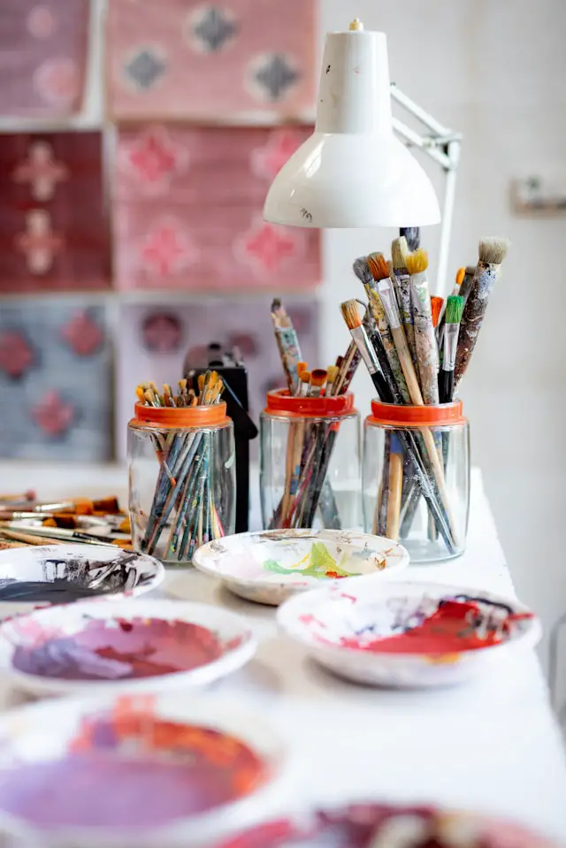 white ceramic plate with paint brushes and paint brushes