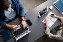 Free Stock Photo of Two professionals working on laptops