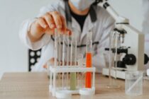 a person holding an empty test tube