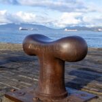 a rusted metal object sitting on top of a wooden dock