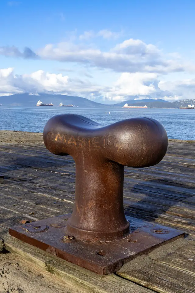 a rusted metal object sitting on top of a wooden dock