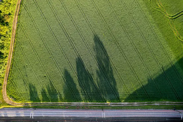 an aerial view of a road and a field