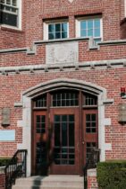 brown wooden door on brown brick building