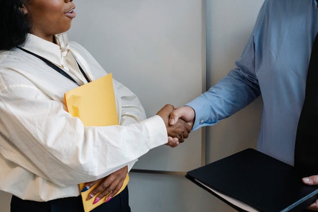 diverse coworkers shaking hands after meeting