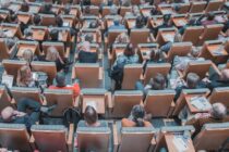 high angle photography of group of people sitting at chairs