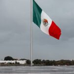 monumental mexican flag waving on a rainy day in puebla