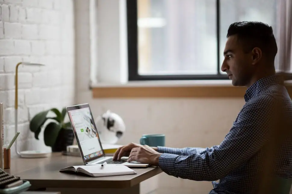 Pro working on a laptop in an office