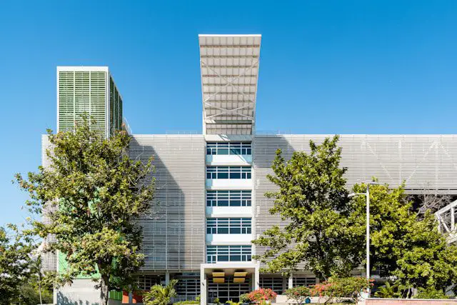 white concrete building near green trees during daytime