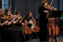 women playing violin near window