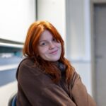 young woman smiling in-classroom setting