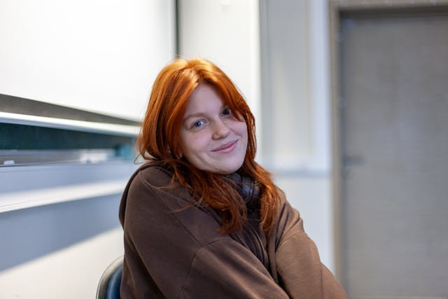 young woman smiling in-classroom setting