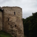 a stone tower with two windows on top of a hill