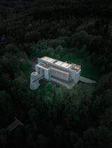 an aerial view of a building surrounded by trees